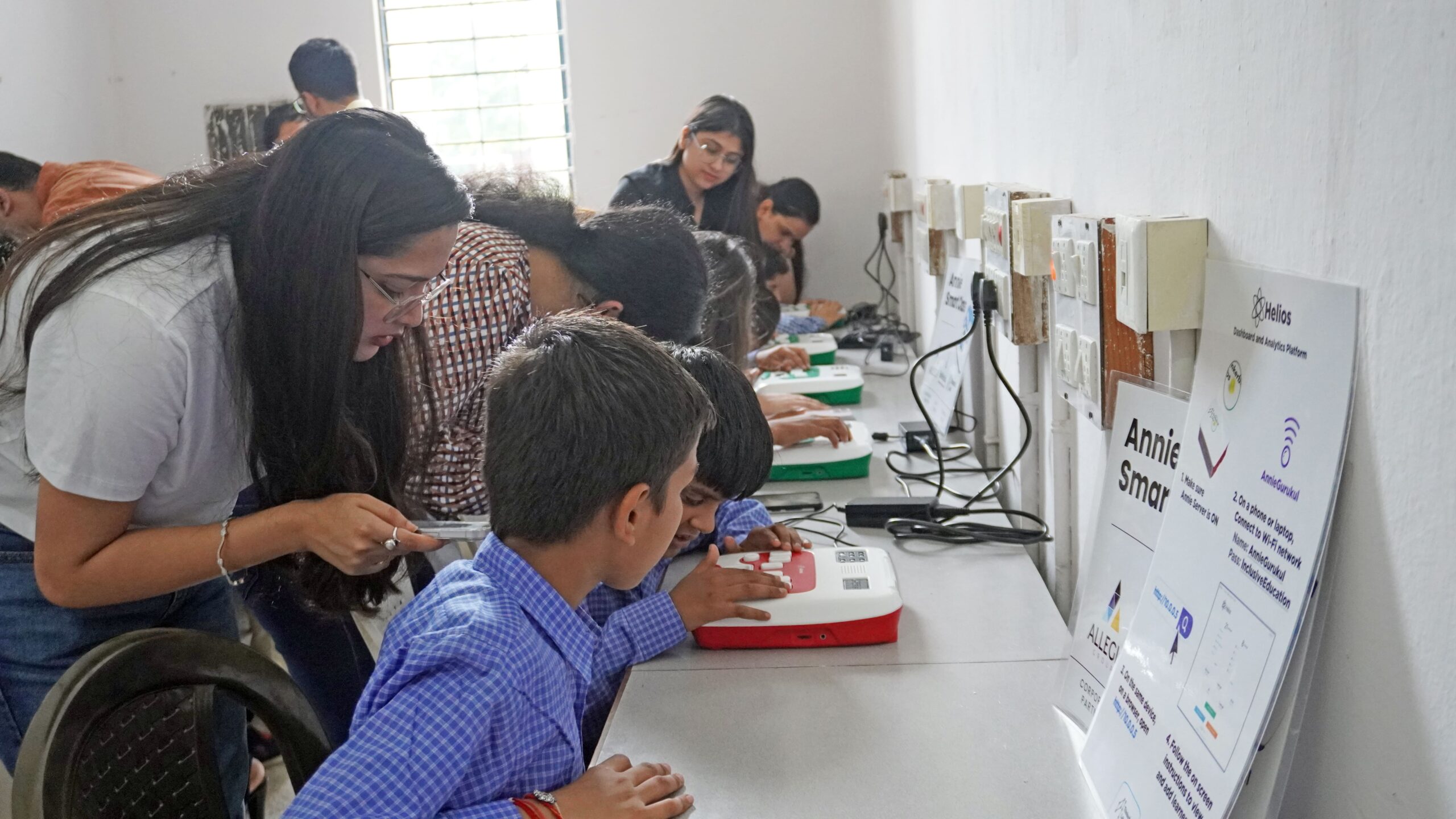 Students with visual impairment learning Braille using assistive devices in a classroom