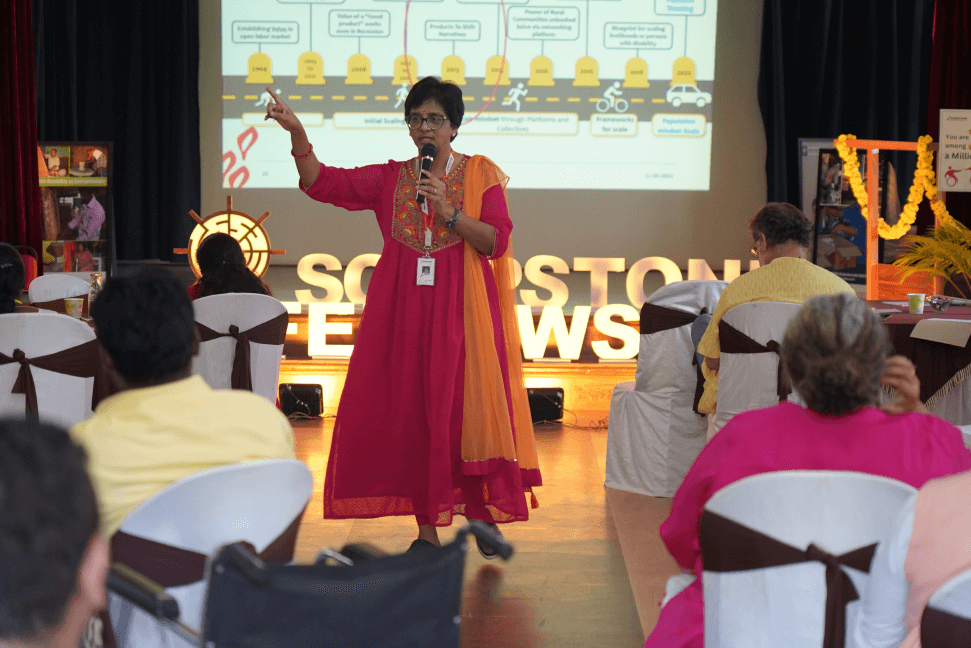 Fellow in red kurta presenting tools and ideas to participants during Soapstone Fellowship