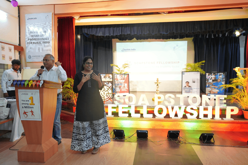 Soapstone Fellow presenting to an audience with sign language interpreter on stage