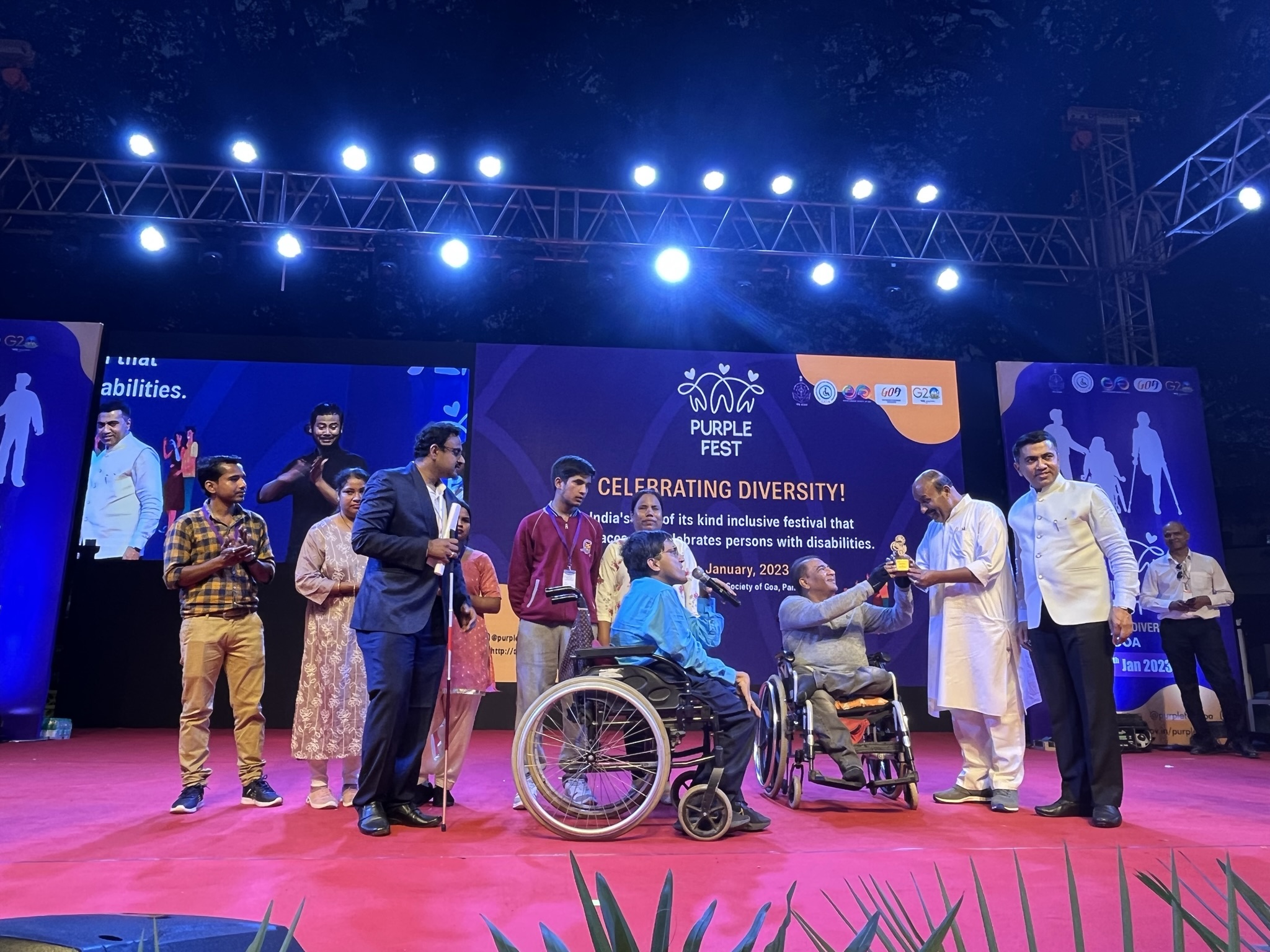 Award ceremony during Project Discovery at Purple Fest 2022 in Goa, with persons with disabilities and dignitaries on stage.